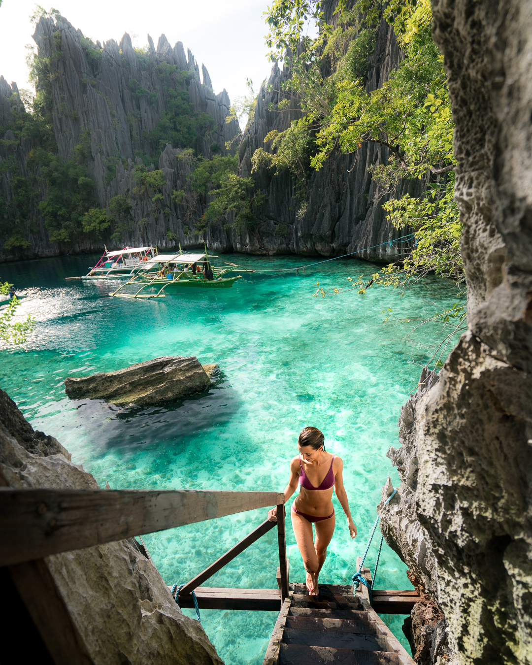 Walking on the staircase that separates the two bodies of water at Twin Lagoon in Coron, Philippines.