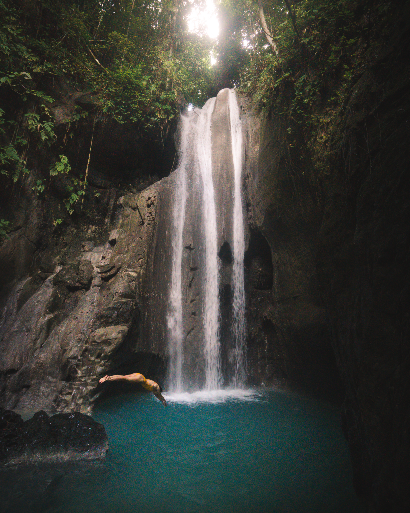 Diving off one of the lower rocks at Binalayan Waterfall, Cebu, Philippines