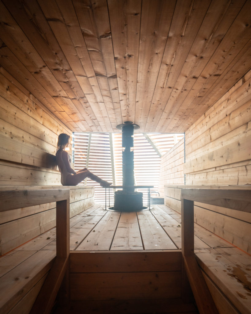 Jess sitting inside a dry wood sauna in Helsinki in winter