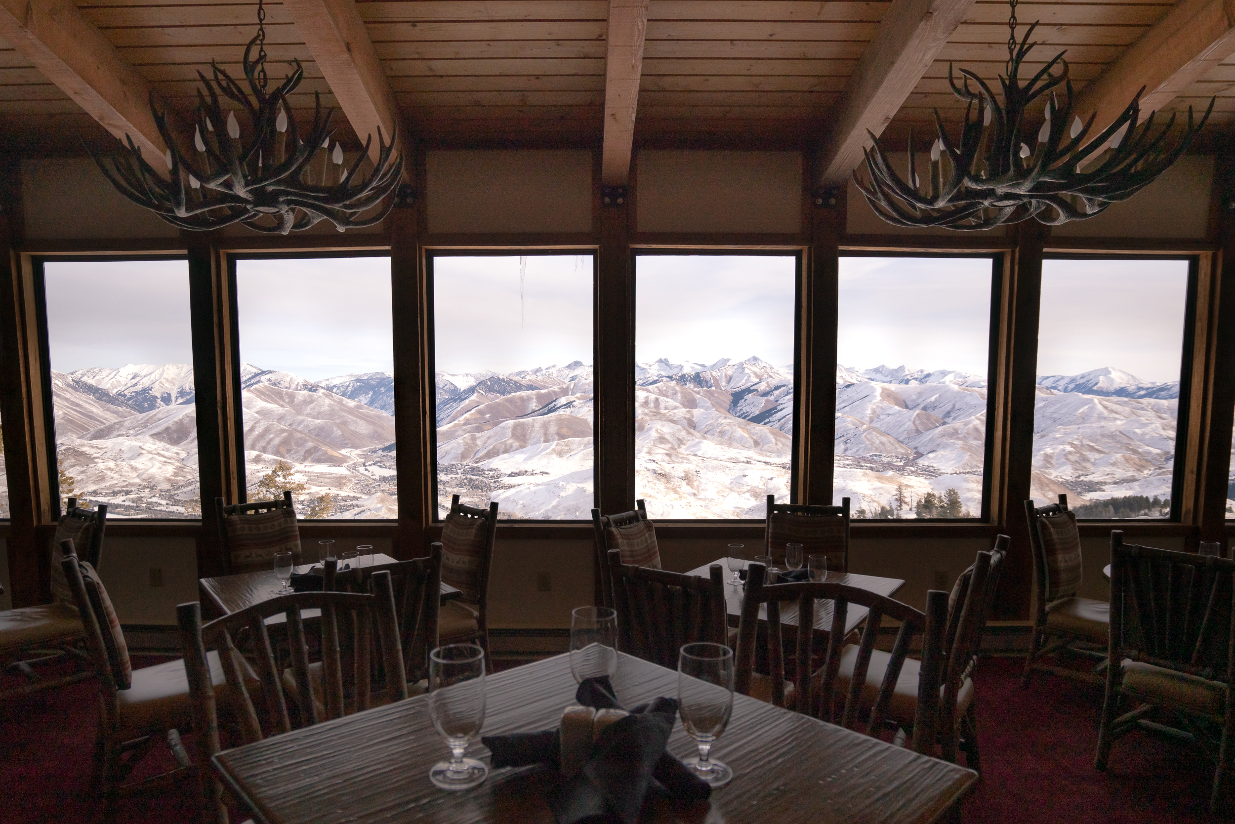 The view from inside the Roundhouse restaurant with a wall of windows showing the snowy mountain range