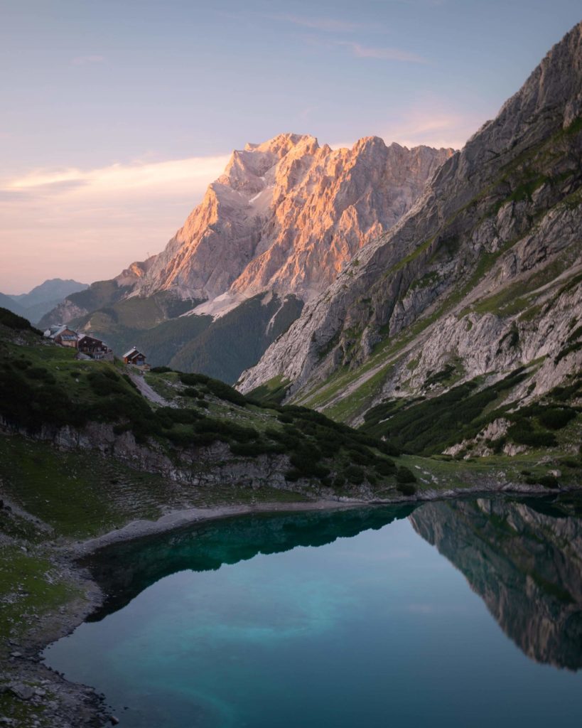 Drachansee in Austria at sunset. You can see Coburger Hütte on the opposite side of the lake