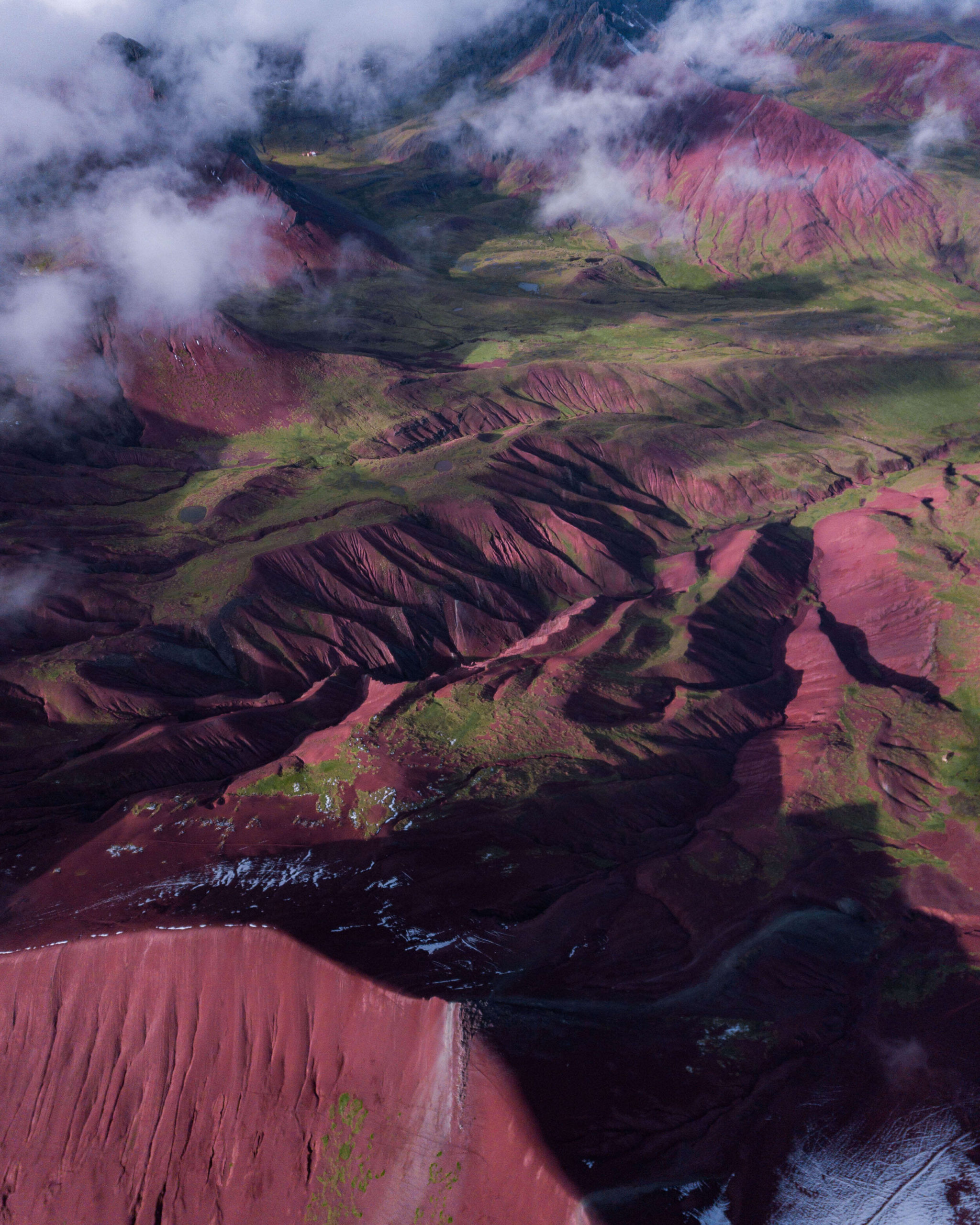 The vivid red colored earth that Rainbow Mountain in Peru is famous. for.