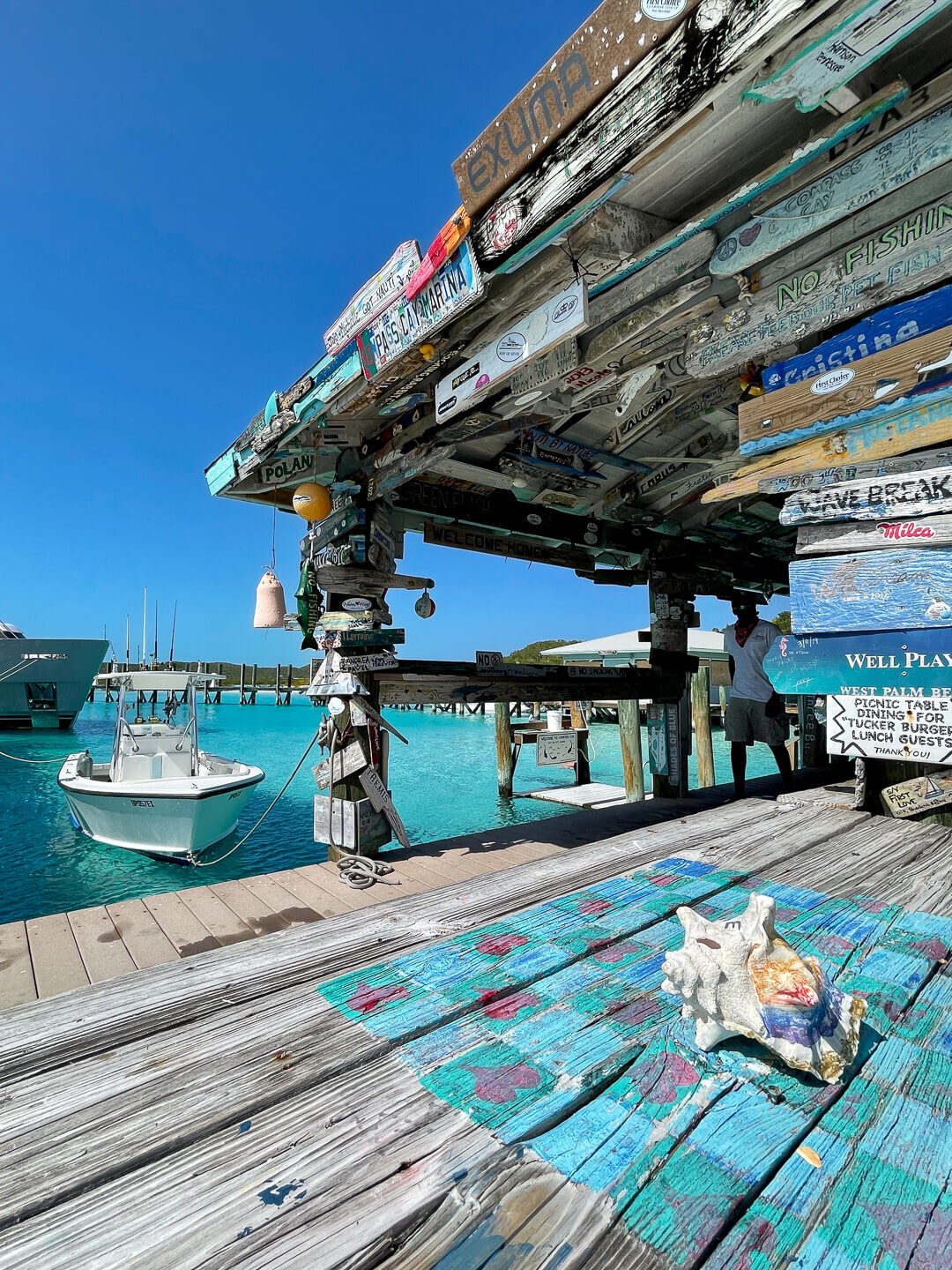 Colorful wood signs left by past travelers give Compass Cay its quirky character.