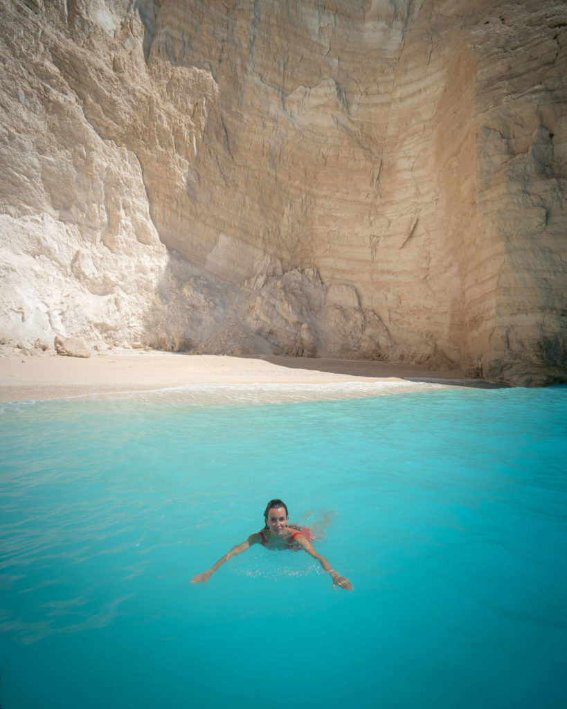 woman swimming in crystal clear water of Zakynthos Greece