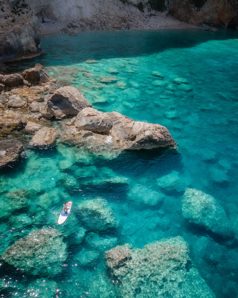 Jess Wandering paddleboarding in Zakynthos Greece in clear blue water