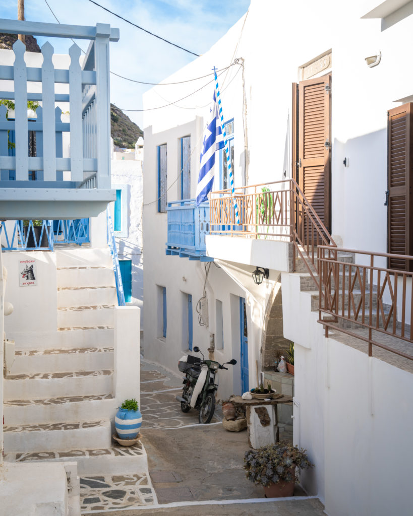 An alleyway with whitewashed houses and blue doorways