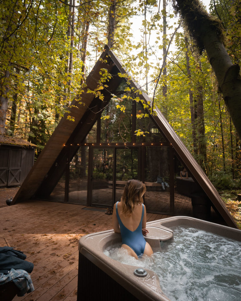 Jess Wandering in hot tub at Sky Haus Cabin in Washington, an a frame cabin in the woods