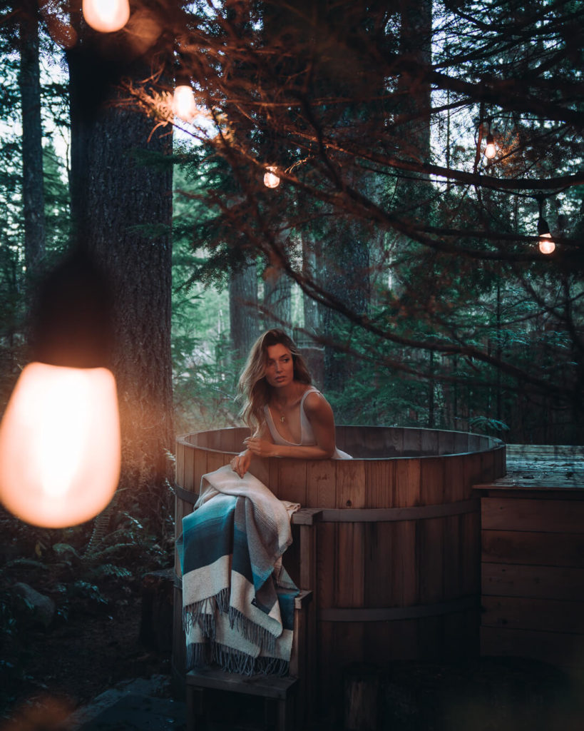 woman in outdoor hot tub at Ohanapecosh by little owl cabin