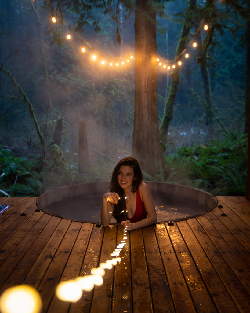 jess wandering in the outdoor hot tub at the Hygge Hus pnw cabin rental