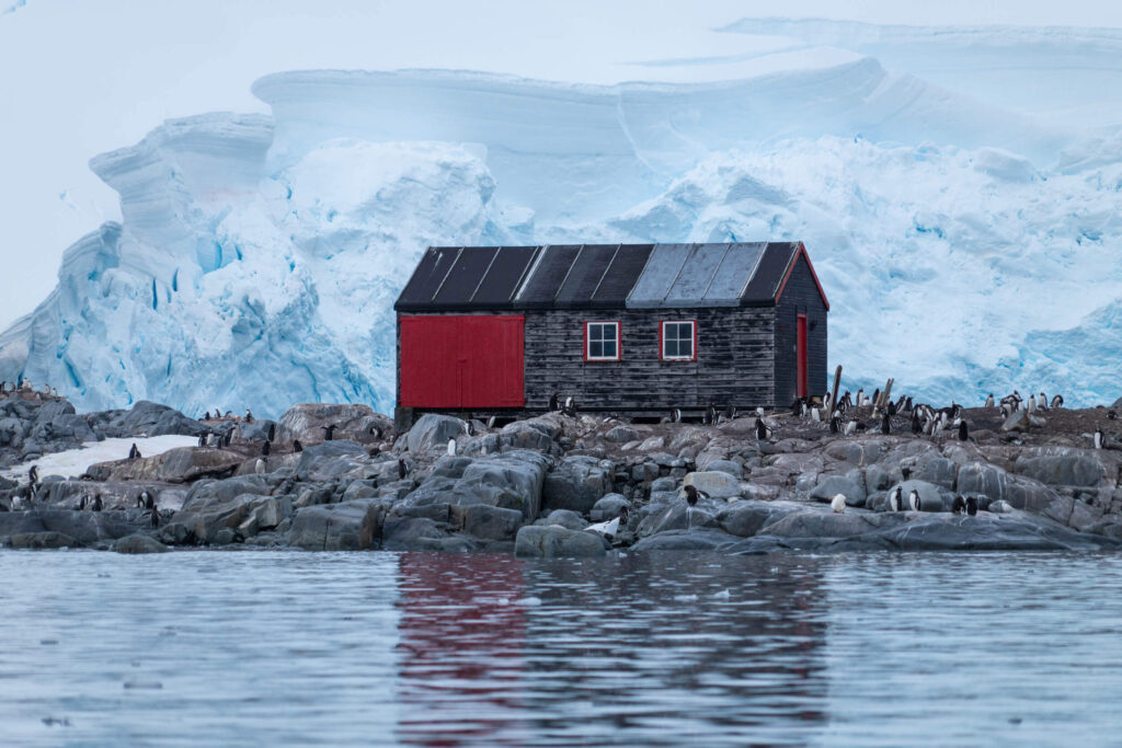 a small wooden and red building housing a museum and post office in Antarctica