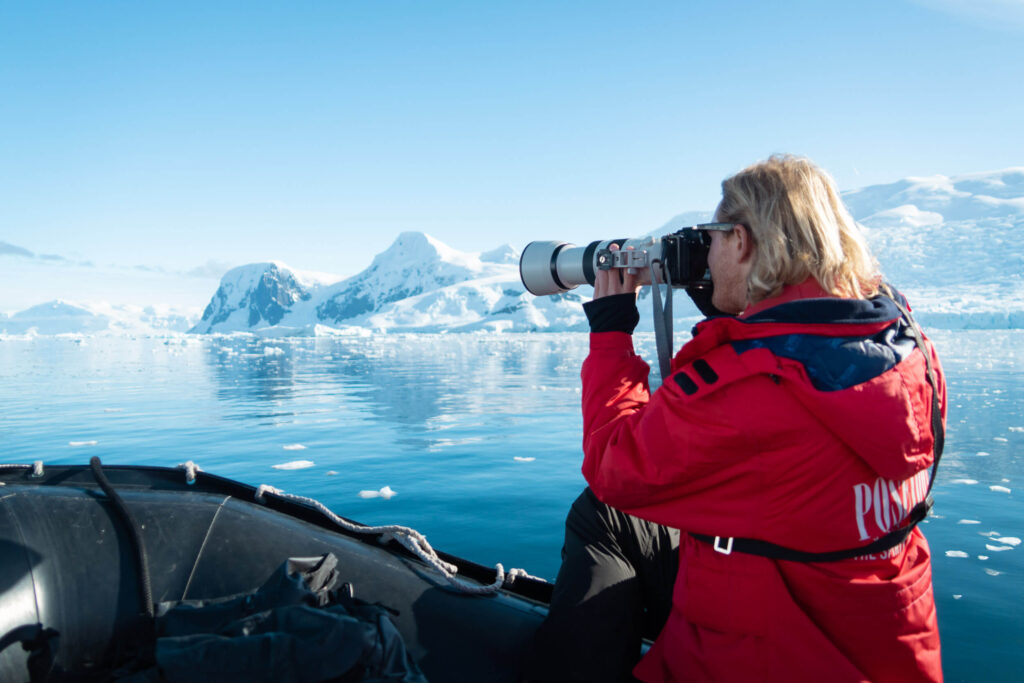 Using a telephoto lens from the zodiac to capture wildlife in Antarctica