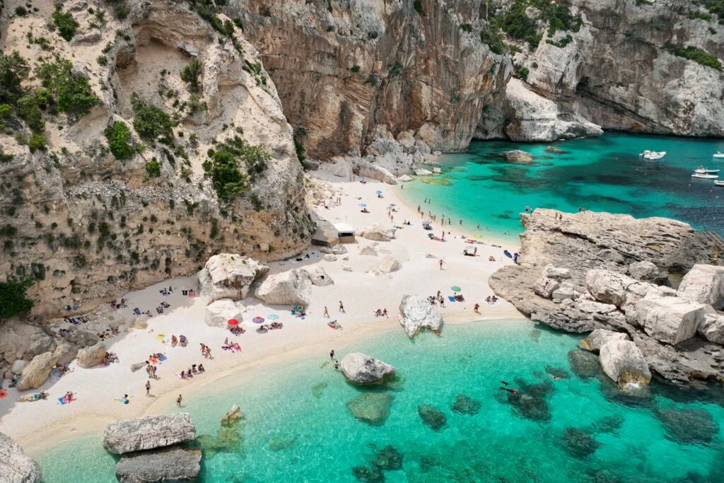 The Gulf of Orosei white sand beaches in Sardinia with turquoise water and rocks