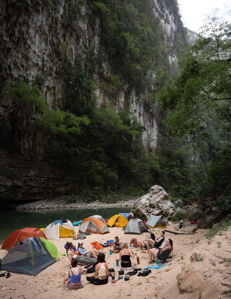Group camping on a river rafting trip