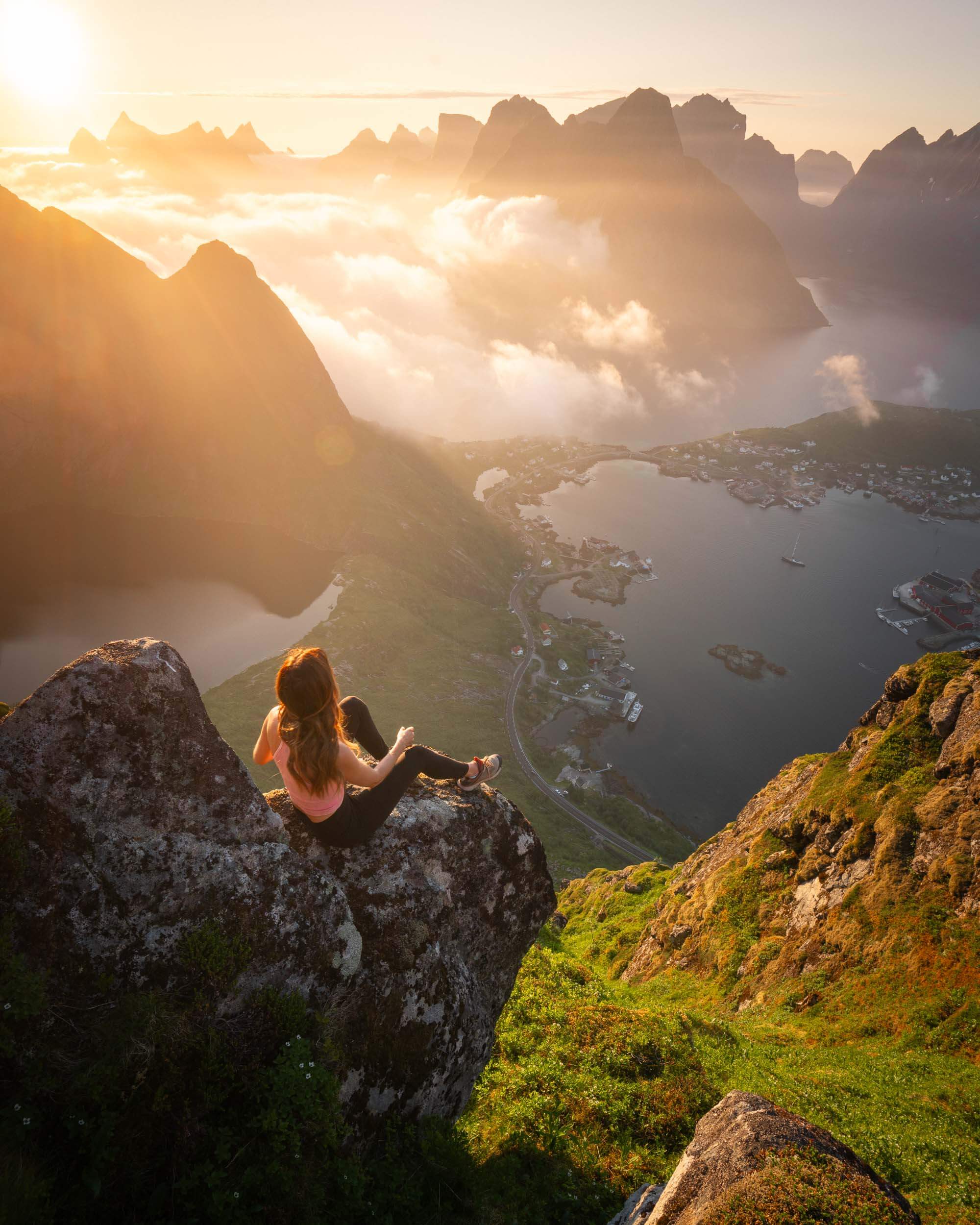 jess wandering watching sunset from the reinebringen hike, one of the best day hikes in the lofoten islands norway