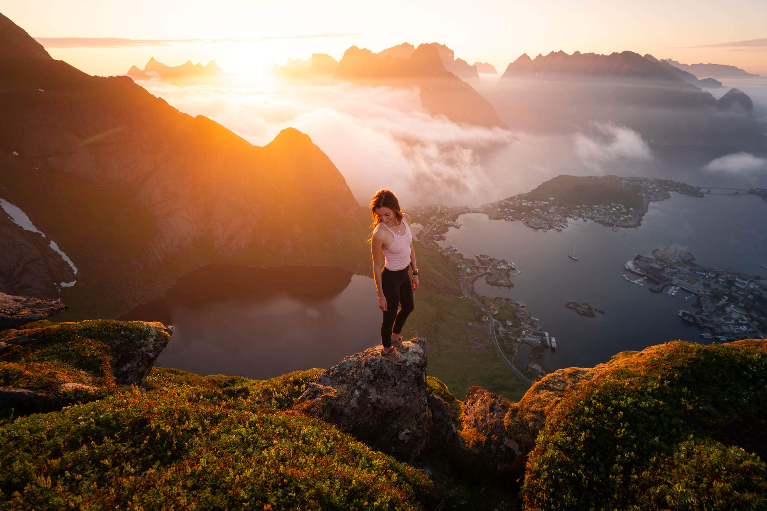 jess wandering at sunset on the reinebringen hike in lofoten islands